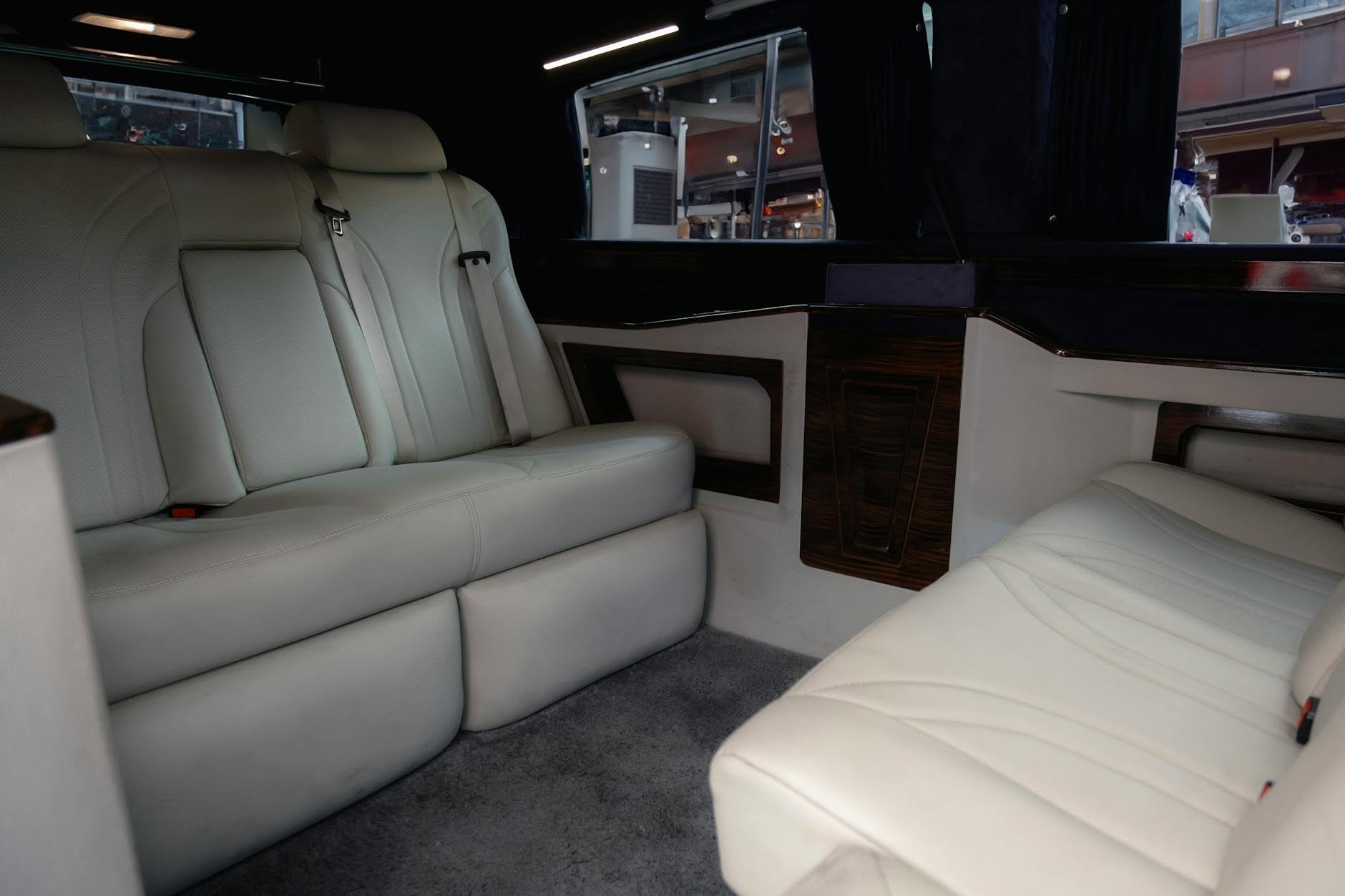 Spacious black leather interior of a Mercedes Sprinter group van, Volantis Limousine Services Sprinter class